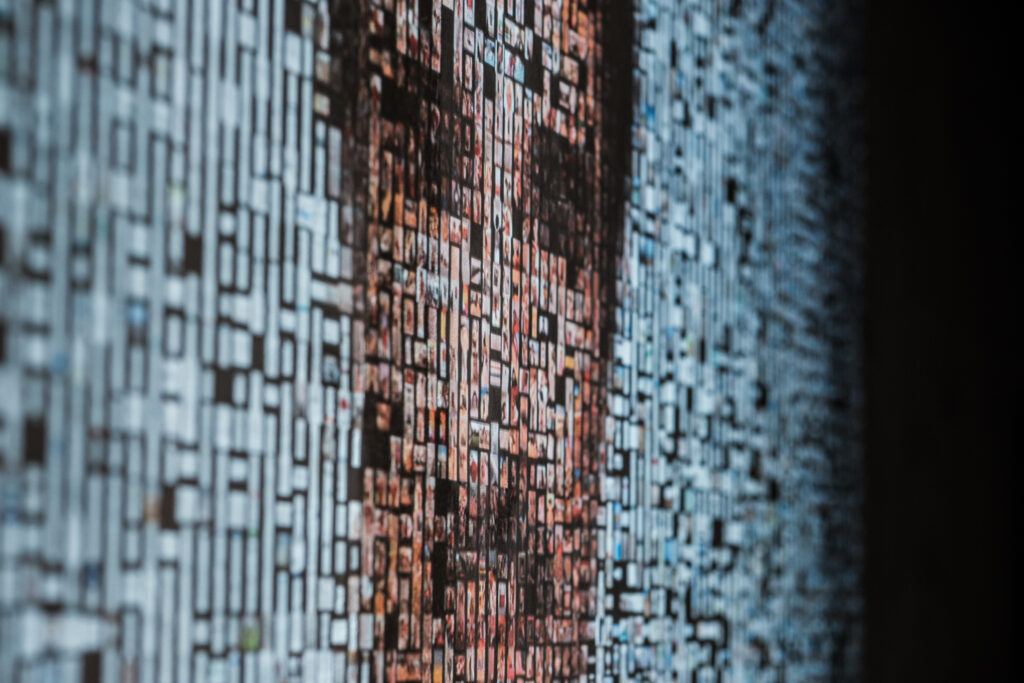 A visitor adds photograph to the archive; the portrait rebuilds in real time