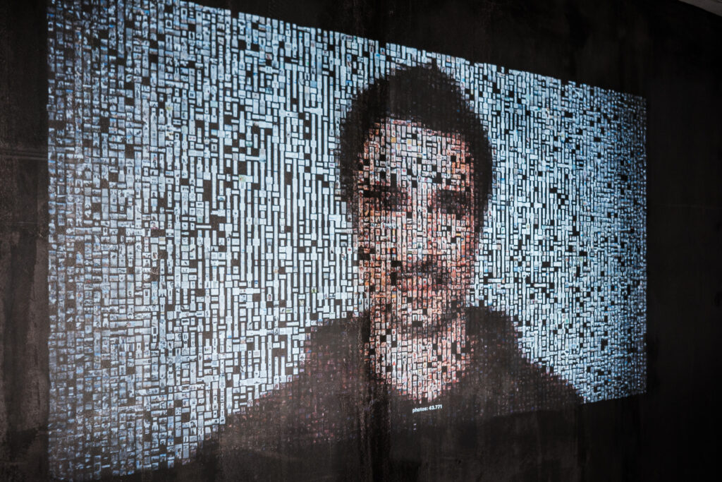 A visitor adds photograph to the archive; the portrait rebuilds in real time
